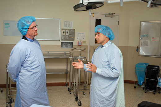 Dr. Bas Masri (right), Surgeon-in-Chief and Head of the Department of Orthopaedics, describes to Minister Terry Lake the process of hip and joint replacement in August 2013.