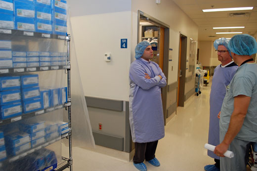 Tools of the trade: Steve Kabanuk (right), director, perioperative services, shows  Minister Terry Lake (centre) and Mario Miniaci, executive assistant to the minister, boxes of joint implants outside UBCH ORs.