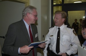Past-mayor Larry Campbell talking to past-deputy police chief Bob Rich at InSite's grand opening in 2003.