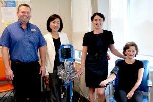 L to R: Jennifer Kim, Owner/Pharmacist, Shoppers Drug Mart, VGH, Ken Beaulieu, Store Manager, Shoppers Drug Mart, VGH, Dr. Tara Sedlak, Director, Leslie Diamond Women’s Heart Health Clinic; and patient Ann Ramsay with blood pressure machine that Shoppers Drug Mart is fundraising for. 