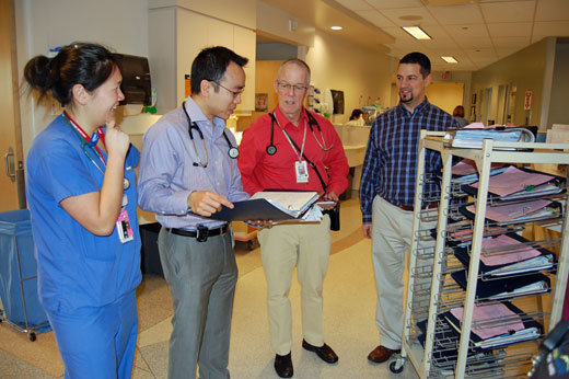 Enhanced patient care meets enhanced learning (left to right): Cassandra Ma, Dr. Dan Lee, Dr. Iain Mackie and Gerry Desilets during rounds on the Acute Medicine Unit at VGH.