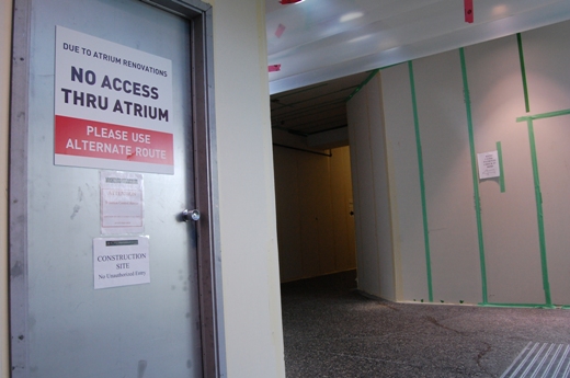 Hoarding in the makeshift hallway at the north end of the atrium.