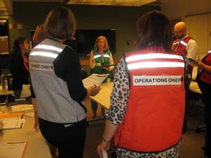 EOC Director leading a briefing in the Emergency Operations Centre.