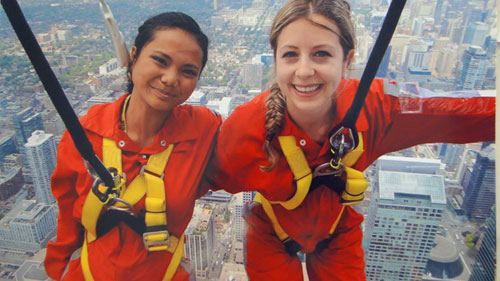 Cates (left) and Isabelle, VGH RNs, are pictured hanging off the top of the CN Tower.