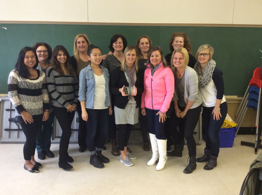 Debbie Brow (front centre, holding engagement award) celebrating with her Public Health team at Richmond