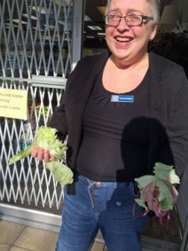 Deborah, a VGH Thrift Store volunteer, holds what’s left of the head of lettuce a dancing lion plucked from the storefront on East Hastings and promptly “spit” out. 