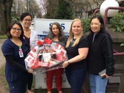 Mary Pack Arthritis Centre staff accept gift basket after winning the team selfie contest