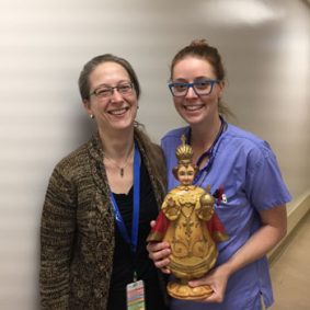 Allana Leblanc (left), critical care practice lead, and Julie Lockington, ICU RN, with the statute of a saint borrowed from a local parish to grant a patient’s wish. 