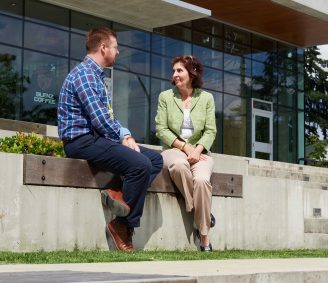 Dale Handley, VCH Clinical Planner, Youth Mental Health and Substance Use Services, chats with admin assistant Del Demheri outside the HOpe Centre.