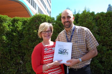 Leanne Appleton, Clinical Director LGH Redevelopment Project, and Mike Nader, Chief Operating Officer - Coastal, hold up a copy of the high-level Concept Plan for the new LGH acute care facility. The team submitted the plan to the Ministry of Health last week, one month ahead of schedule.