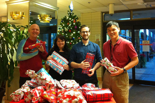 Banfield team members (l to r): Michael Dagenais and Natalie Chapman, activity workers; Jason Thorne, occupational therapist; and Yee-Sin Law, activity worker, with thoughtfully chosen gifts for residents.