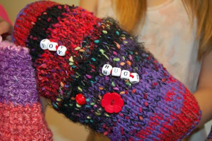Comfort mitts are accessorized with buttons, ribbons and other items to give patients something to fidget with and relieve anxiety.