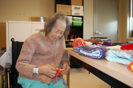 VGH patient Shui Ping Dang enjoys knitting and is doing her part to grow the supply of comfort mitts for future patients.